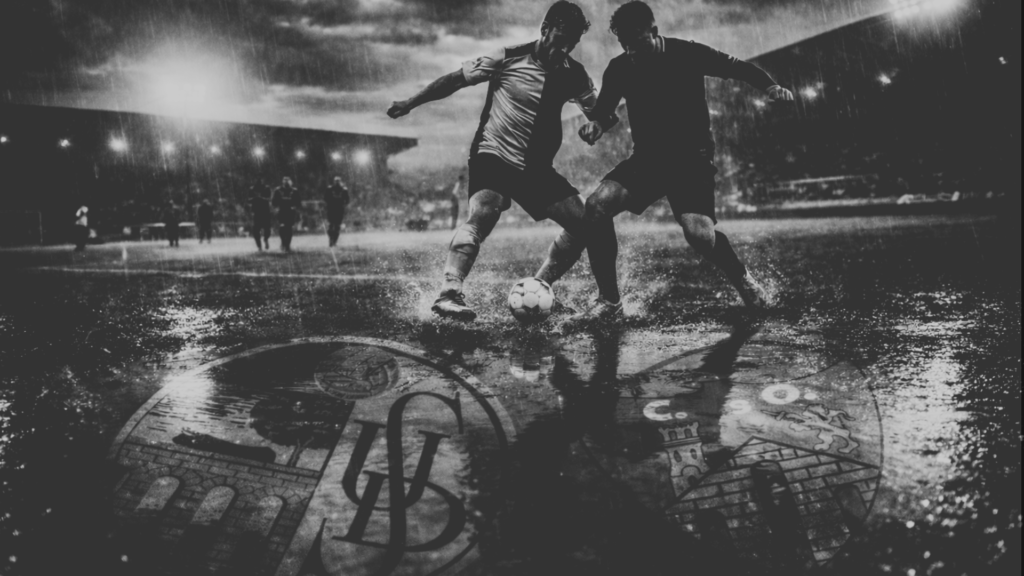 Duelo de jugadores de Unionistas de Salamanca y Ourense CF disputando un balón bajo la lluvia.